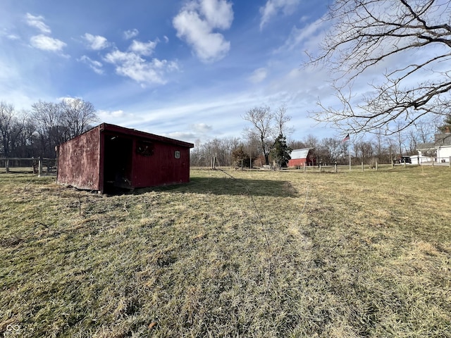 view of yard with a rural view and a storage unit