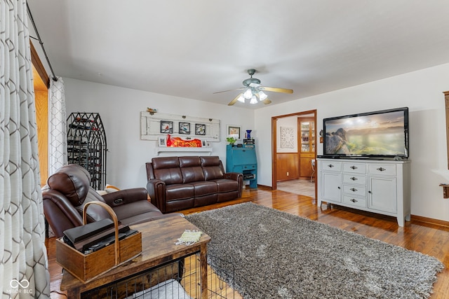 living room with hardwood / wood-style flooring and ceiling fan