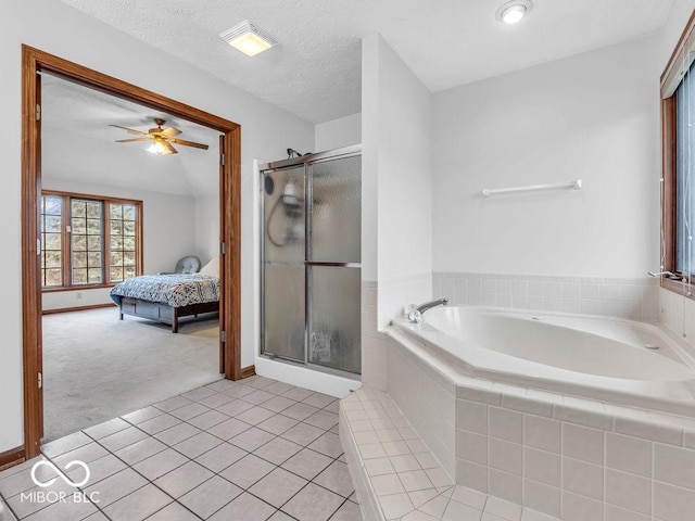 bathroom with tile patterned floors, ceiling fan, separate shower and tub, and a textured ceiling