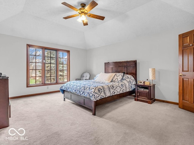 carpeted bedroom featuring ceiling fan, a textured ceiling, and vaulted ceiling