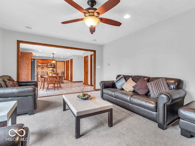 living room featuring light carpet and ceiling fan