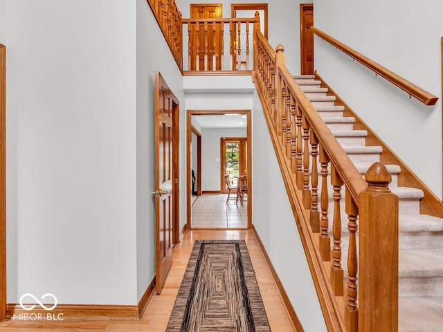 staircase with hardwood / wood-style floors