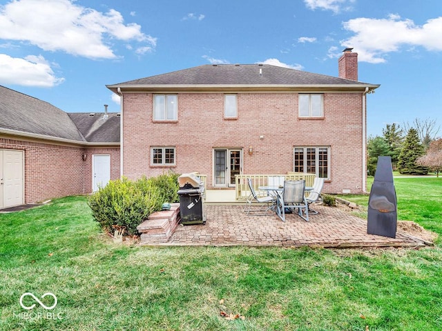 rear view of property with a yard and a patio