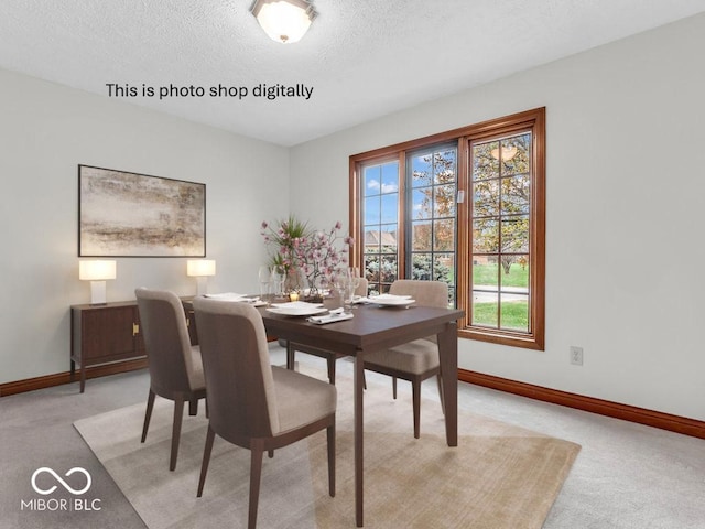 dining space with light colored carpet and a textured ceiling