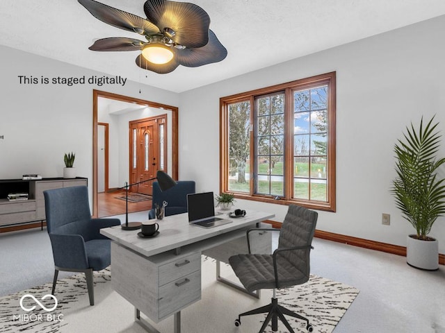 carpeted office featuring ceiling fan