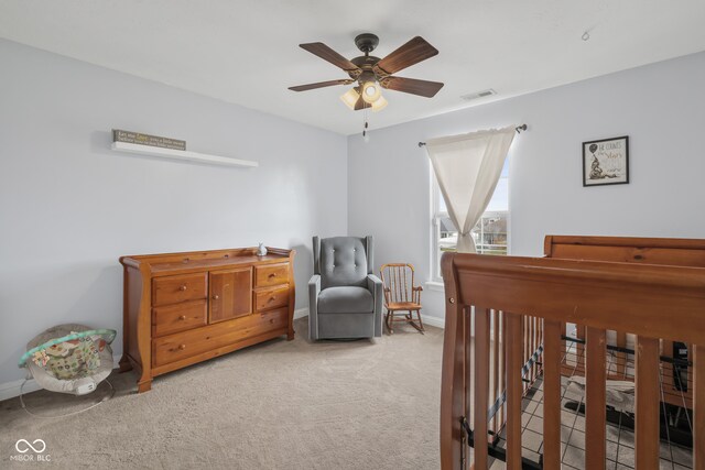 bedroom featuring light carpet and ceiling fan