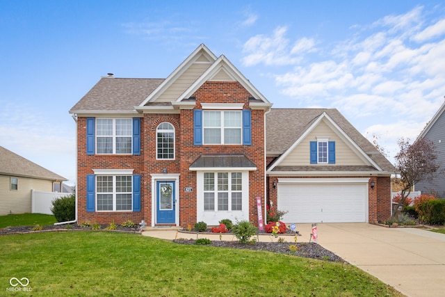 view of front of property with a front yard and a garage