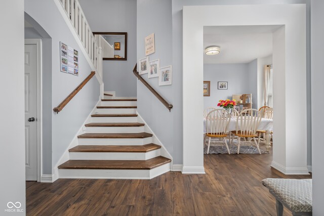 stairs featuring hardwood / wood-style floors