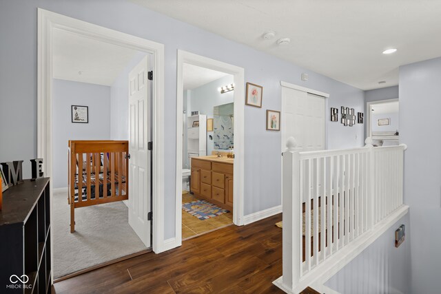 corridor with dark hardwood / wood-style flooring