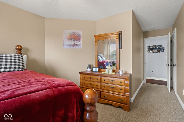 carpeted bedroom with a textured ceiling