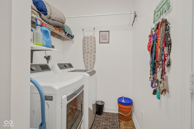 laundry room with independent washer and dryer and tile patterned flooring