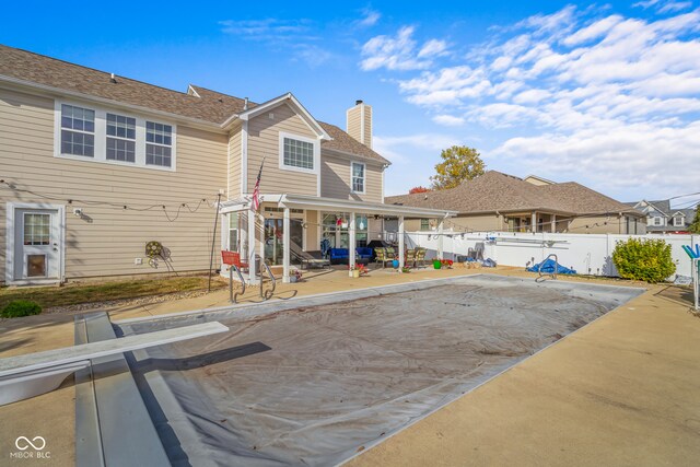 back of property with a patio