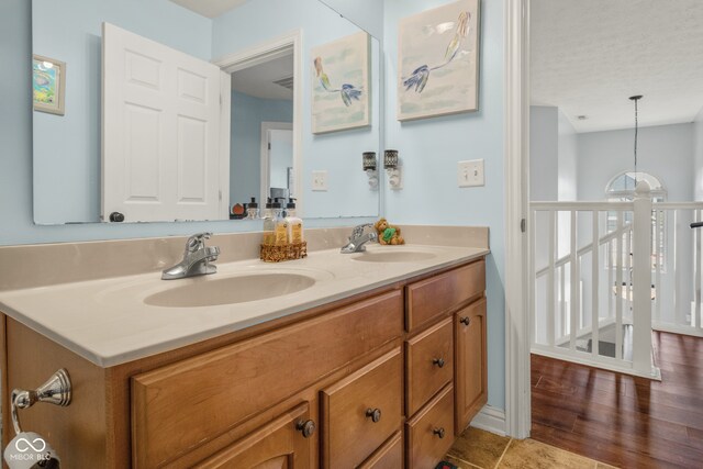 bathroom featuring vanity, a textured ceiling, and wood-type flooring