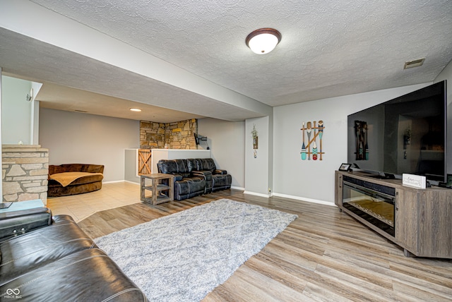 living room featuring a textured ceiling and light wood-type flooring