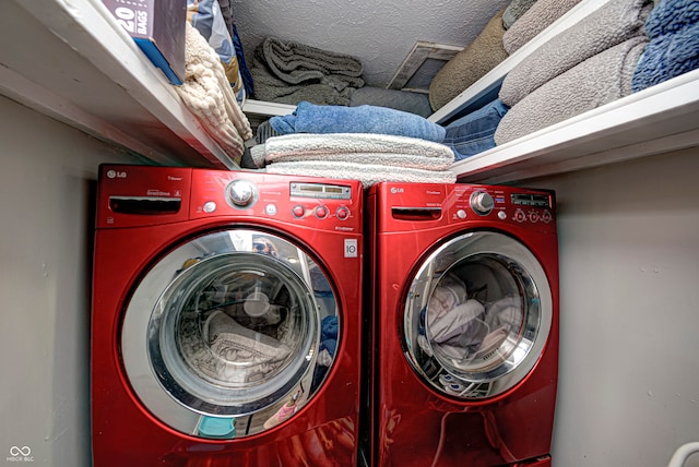 laundry area featuring washer and dryer and a textured ceiling