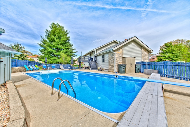 view of pool featuring a patio and a diving board