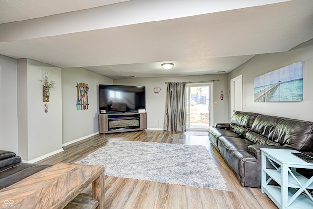 living room featuring wood-type flooring and a textured ceiling