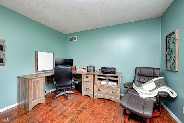 office featuring dark hardwood / wood-style floors and a textured ceiling