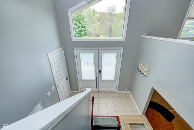 foyer entrance featuring a high ceiling and light tile patterned floors