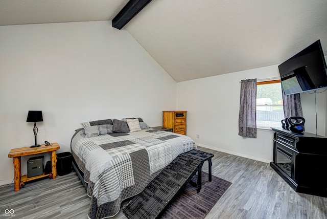 bedroom with lofted ceiling with beams and wood-type flooring