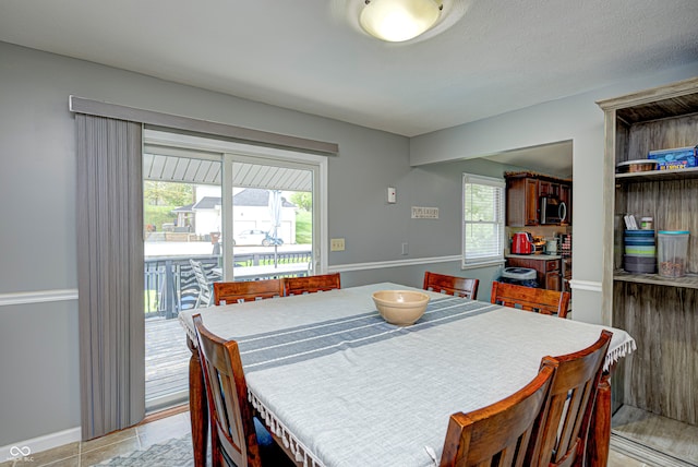 dining room with a textured ceiling and light tile patterned floors