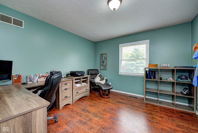 office area with a textured ceiling and dark hardwood / wood-style floors