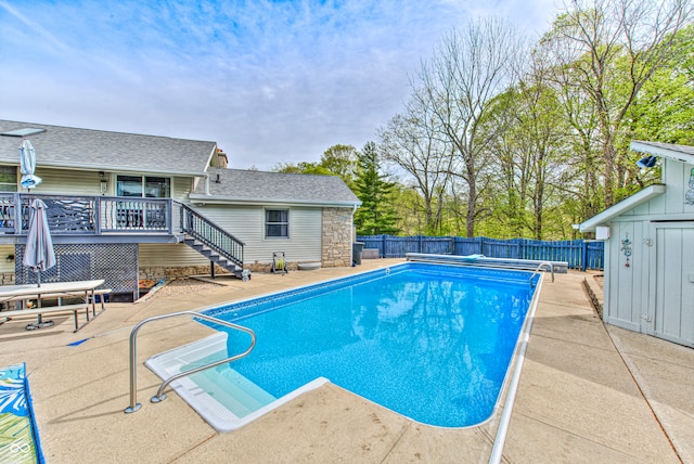 view of pool with a patio and a wooden deck