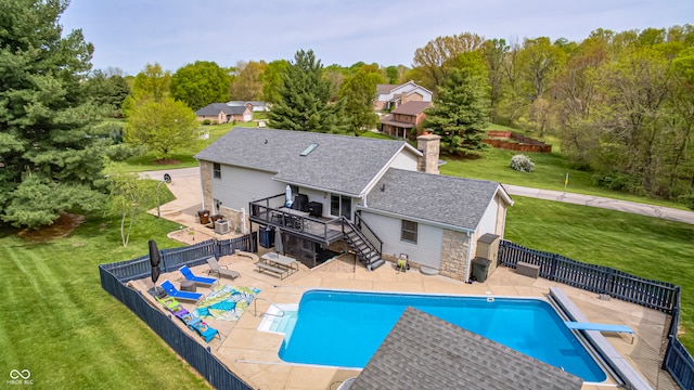 view of swimming pool with a yard, a patio area, and a diving board