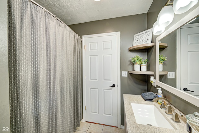 bathroom featuring vanity, a textured ceiling, tile patterned floors, and a shower with shower curtain