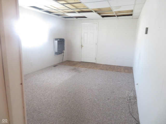 empty room with carpet and a drop ceiling