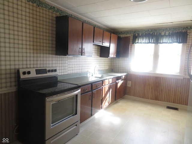 kitchen with stainless steel range with electric stovetop and sink