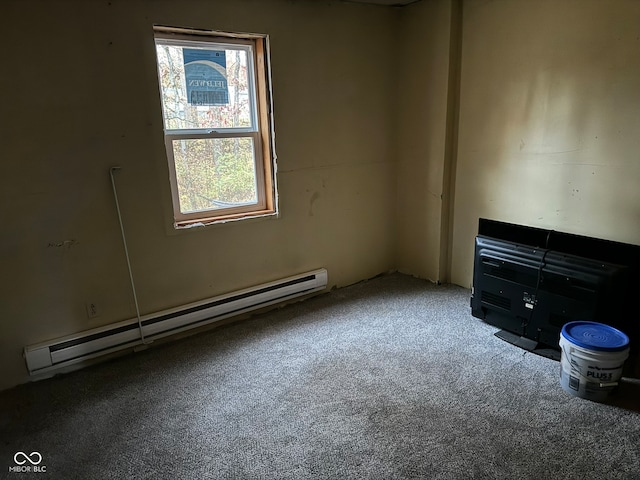 unfurnished room with baseboard heating and carpet