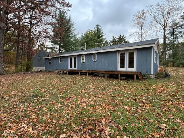 rear view of property featuring a lawn