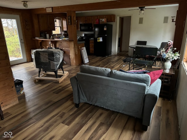 living room with dark hardwood / wood-style floors and ceiling fan