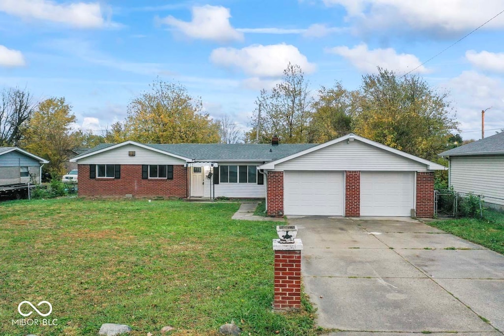 single story home featuring a garage and a front lawn