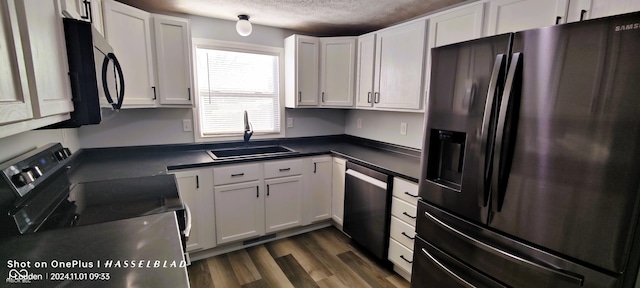 12544 S State Road 3, Westport, IN 47283 - kitchen featuring black appliances, a sink, dark countertops, white cabinets, and a textured ceiling