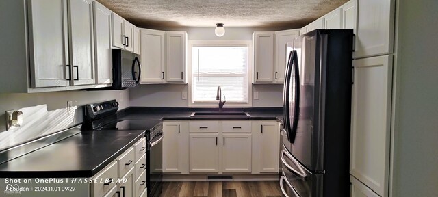 12544 S State Road 3, Westport, IN 47283 - kitchen with black appliances, a sink, a textured ceiling, dark countertops, and white cabinets