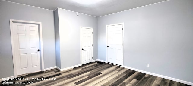 unfurnished bedroom featuring dark wood-type flooring