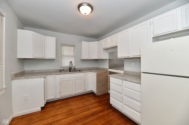 kitchen featuring white refrigerator, dark hardwood / wood-style flooring, white cabinetry, and sink