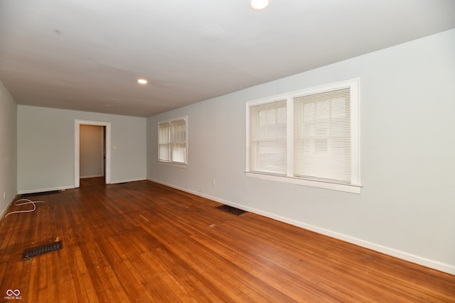 empty room with dark hardwood / wood-style flooring