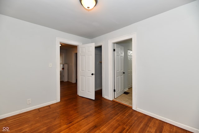 spare room with dark wood-type flooring