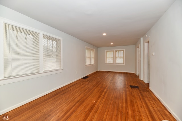 unfurnished room with hardwood / wood-style flooring