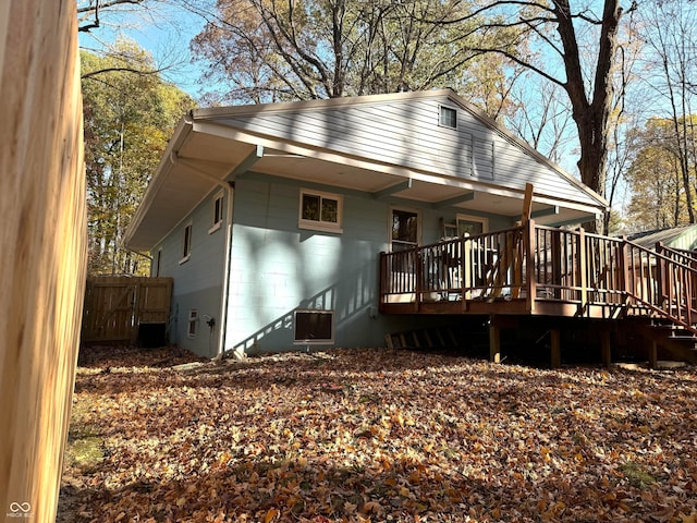 rear view of house featuring a wooden deck