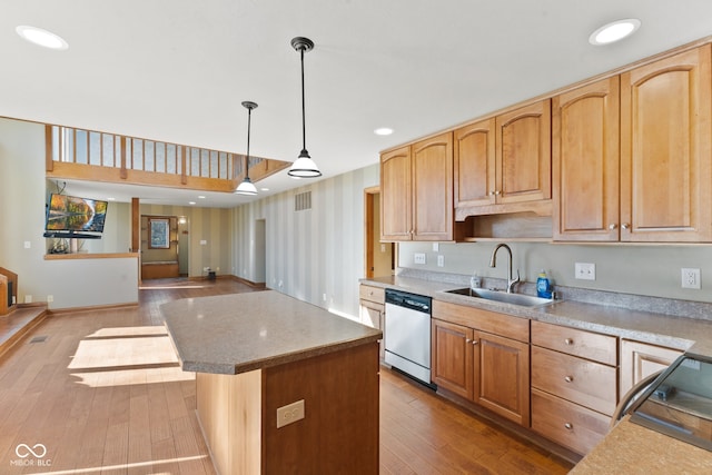 kitchen with a kitchen island, stainless steel dishwasher, dark hardwood / wood-style floors, pendant lighting, and sink