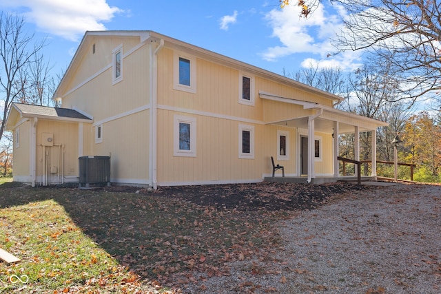 rear view of property with central AC