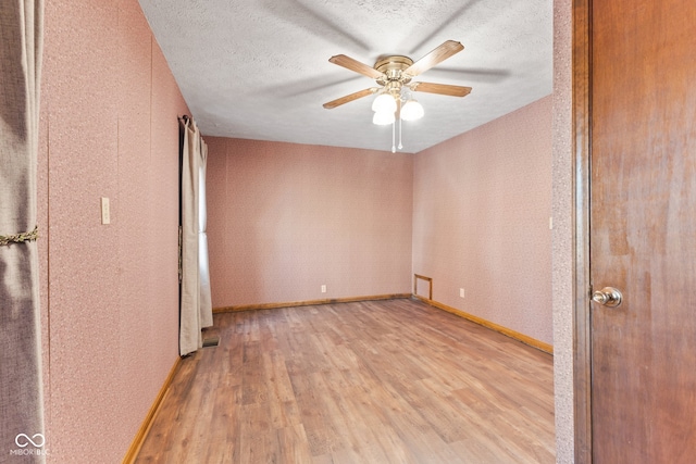 unfurnished bedroom with ceiling fan, a textured ceiling, and light wood-type flooring