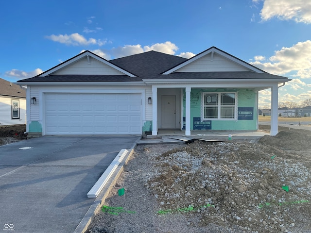 view of front of house with a porch and a garage