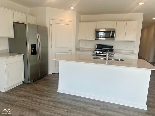 kitchen with white cabinetry, stainless steel appliances, and a sink