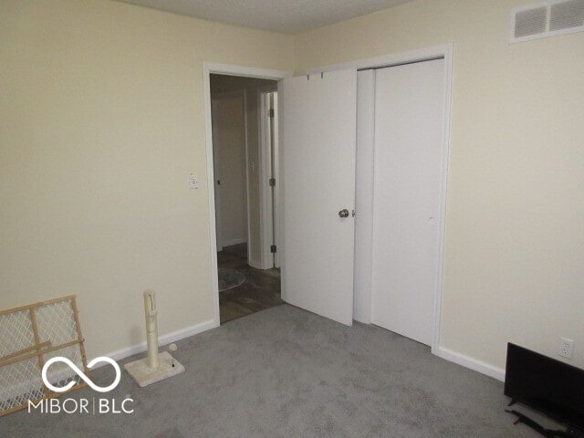 unfurnished bedroom featuring a closet and carpet flooring