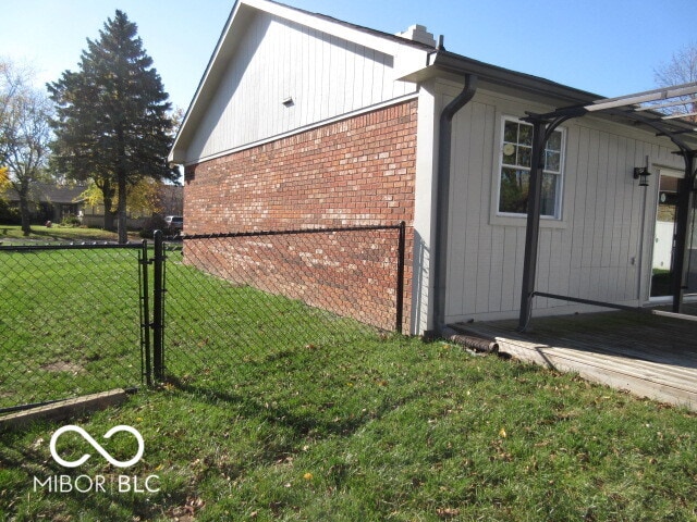 view of side of home featuring a yard